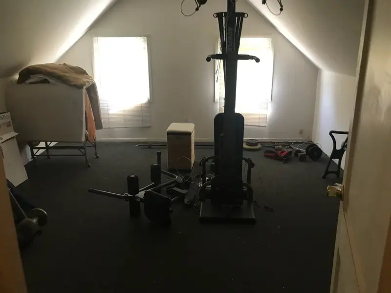 Attic room with exercise equipment and boxes, Levittown, NY