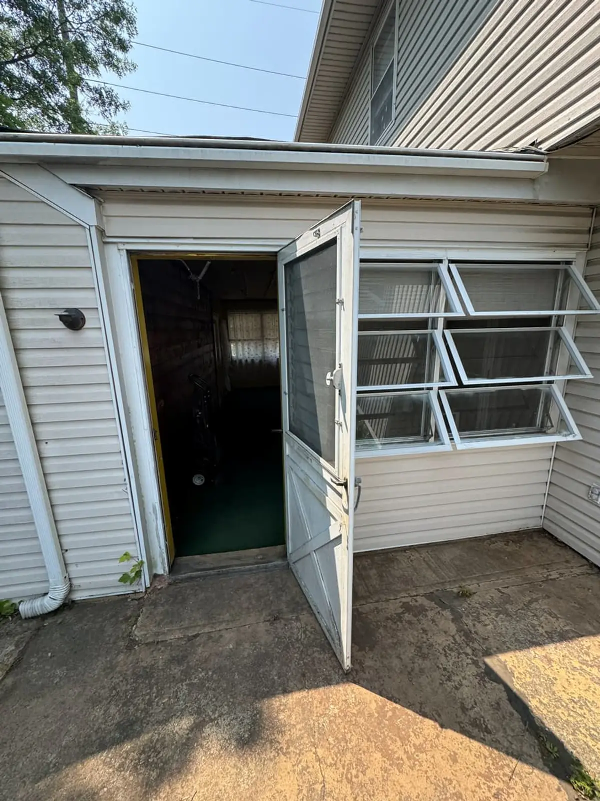 Trying to stop a foreclosure in Levittown: back door off a concrete patio between two wings