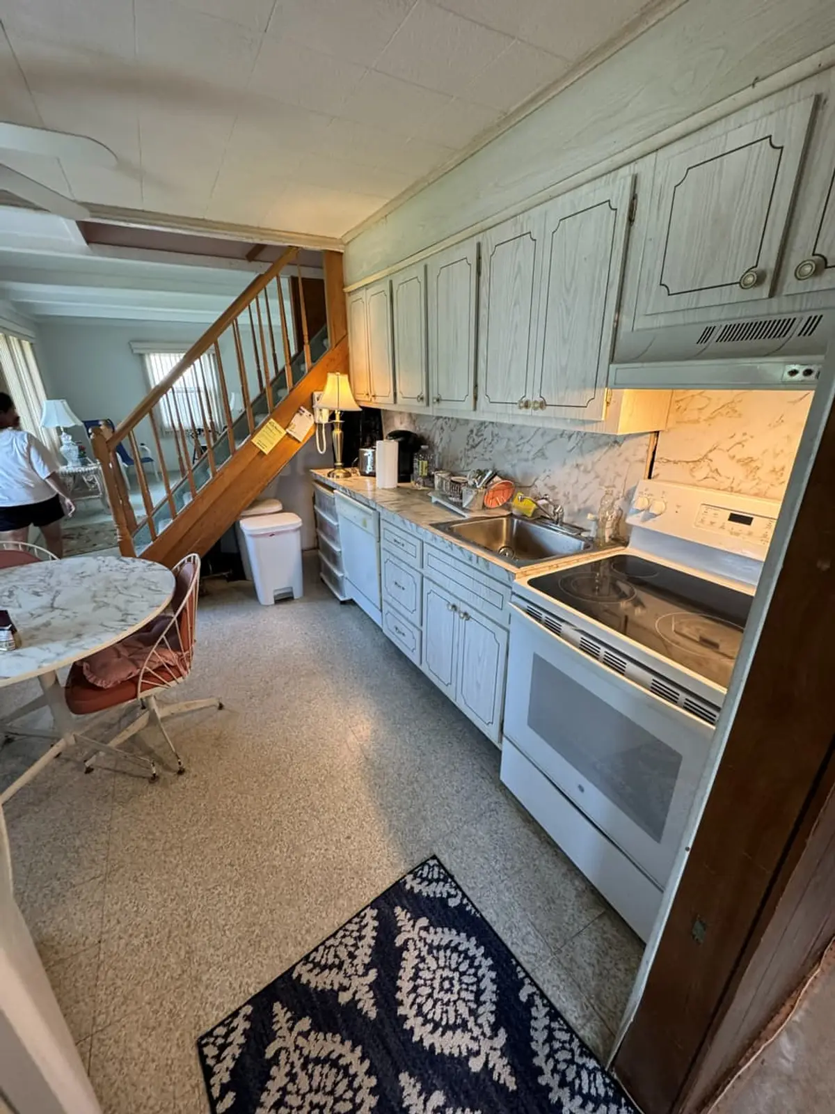Selling a house after a life change in Levittown: kitchen with painted cabinets and a speckled floor